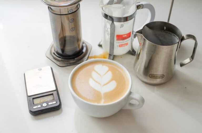 A white mug with a homemade latte and tulip latte art.