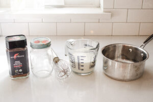 All of the ingredients and equipment needed to make an easy homemade latte without a machine.