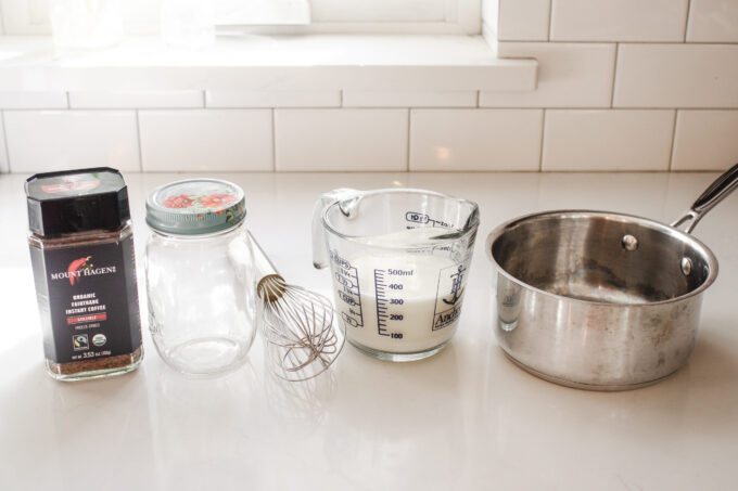 All of the ingredients and equipment needed to make an easy homemade latte without a machine.