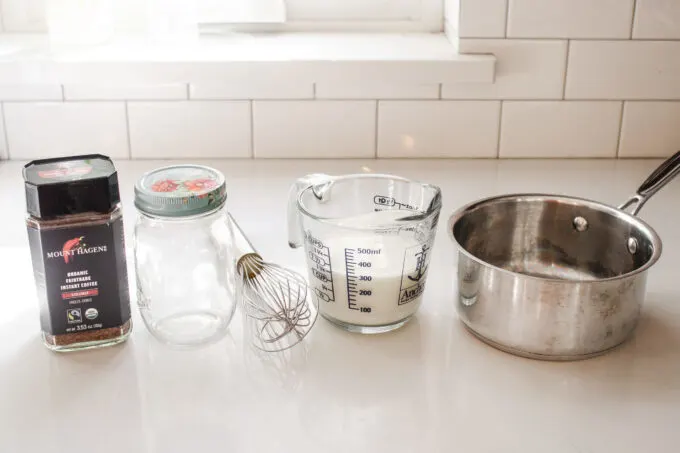 All of the ingredients and equipment needed to make an easy homemade latte without a machine.