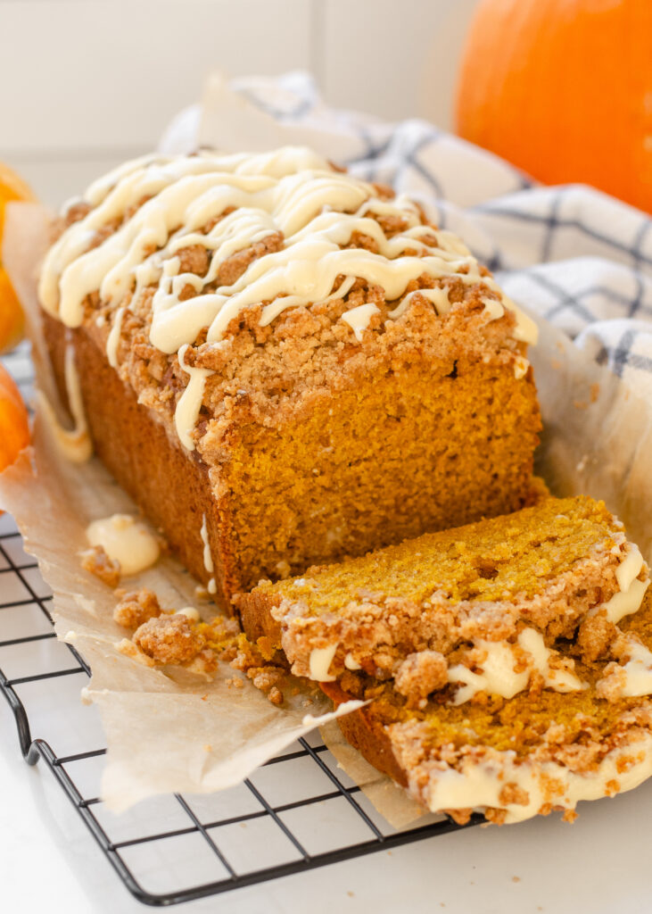 A loaf of sourdough pumpkin bread with a few slices cut.