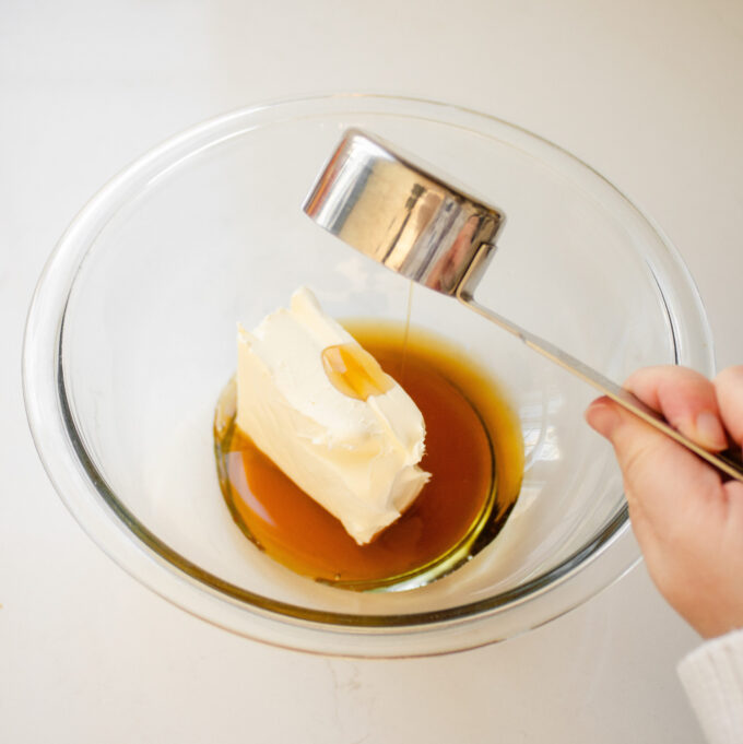 Adding the cream cheese and maple syrup to a bowl.