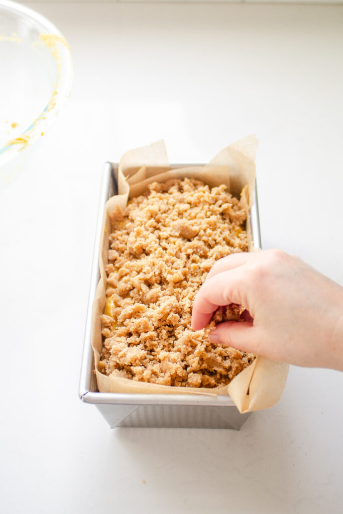 Sprinkling the streusel on top.