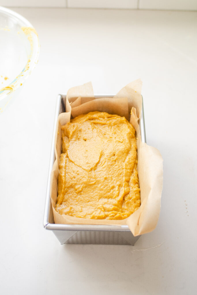 The sourdough pumpkin batter in the lined bread pan.