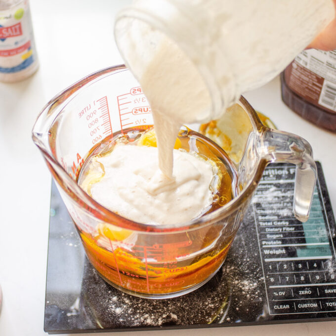 Mixing together the wet ingredients in a measuring cup.