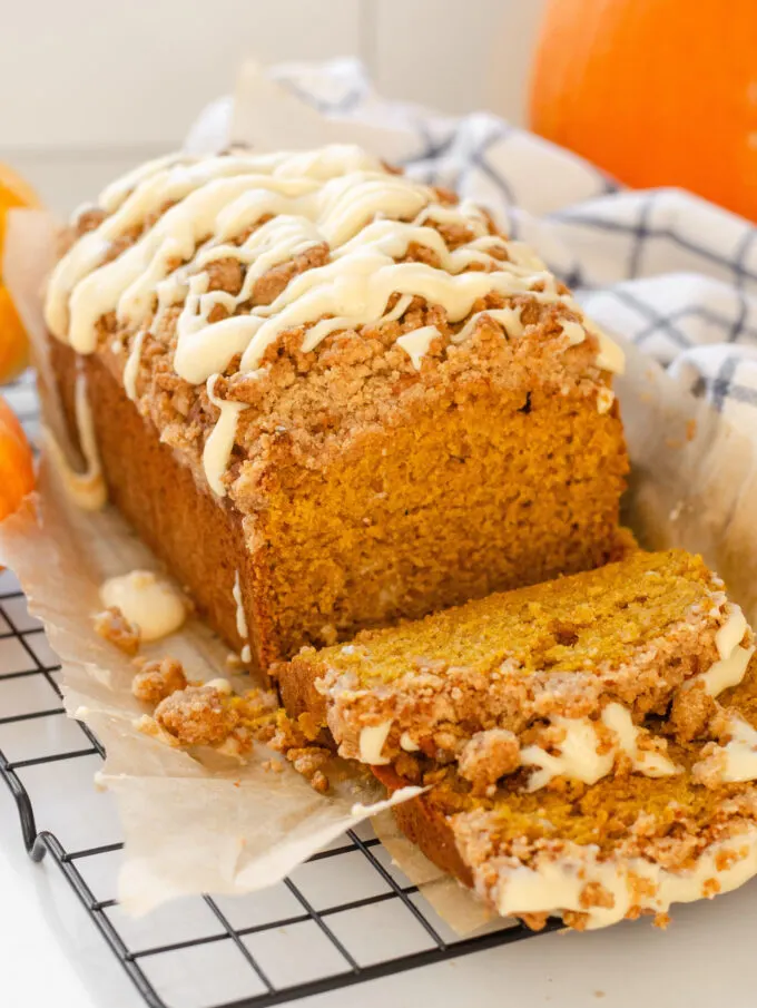 A loaf of sourdough pumpkin bread with a few slices cut.