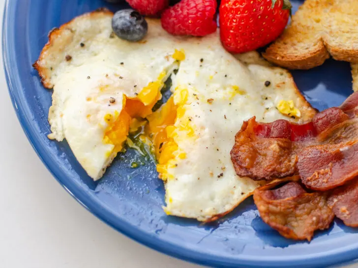 An over medium egg cut open to show how cooked the yolk is.