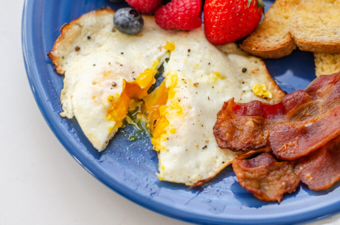 An over medium egg cut open to show how cooked the yolk is.