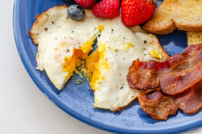 An over medium egg cut open to show how cooked the yolk is.