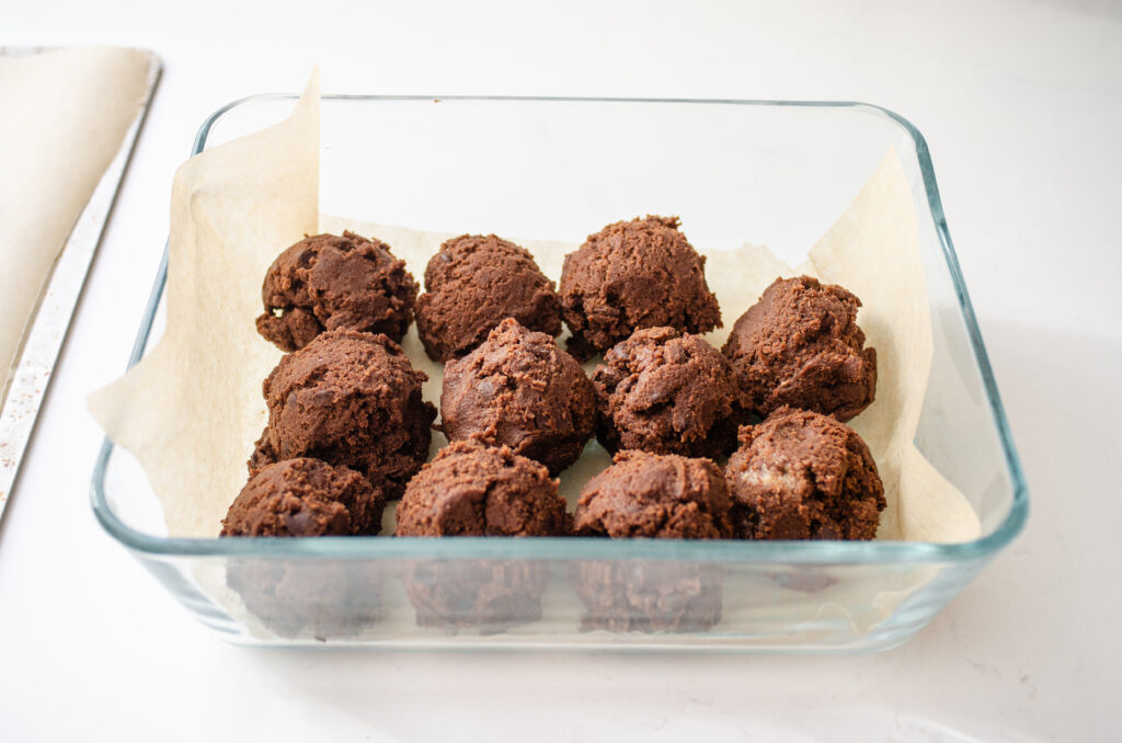 Balls of cookie dough in an airtight container.