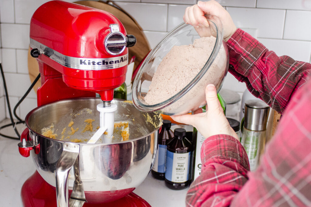 Adding the dry ingredients to the butter/sugar mixture in the stand mixer.