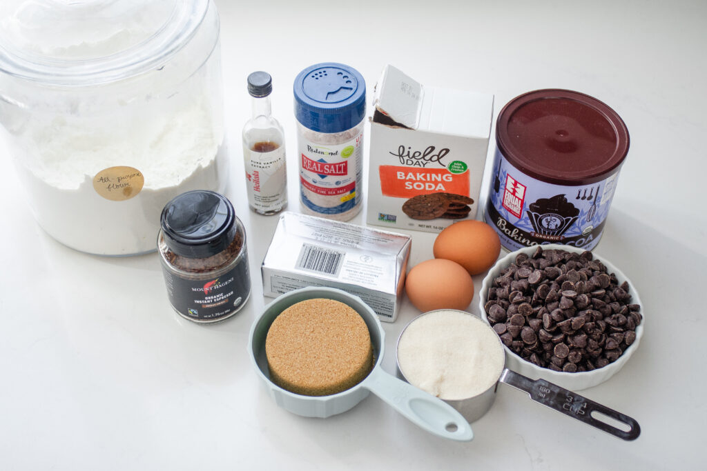 All of the ingredients needed to make chocolate espresso cookies laid out on a white countertop.