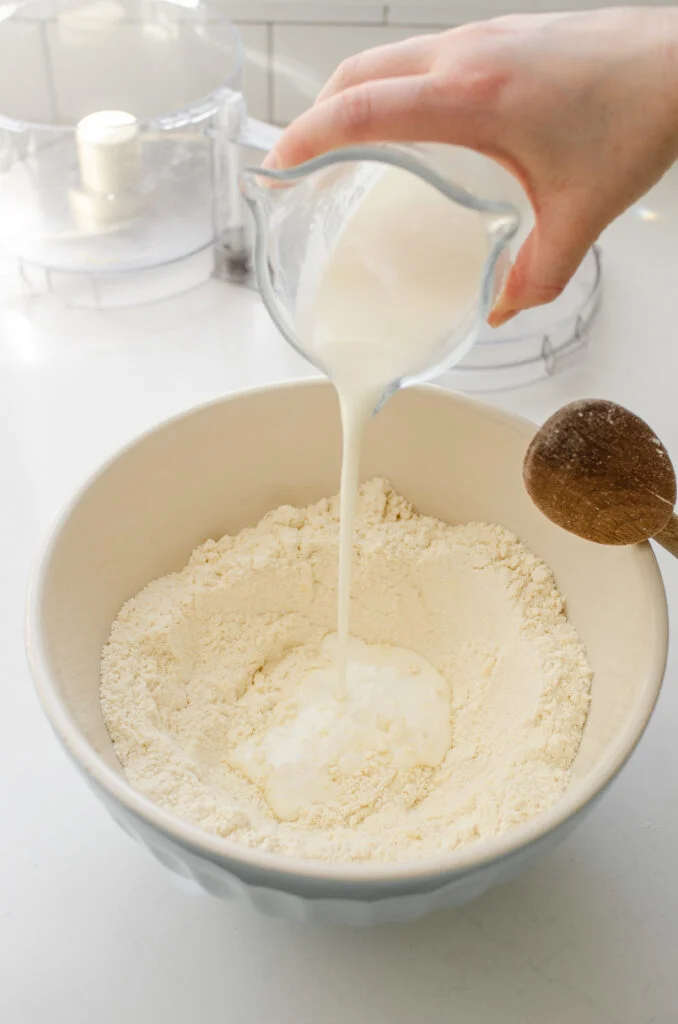 Pouring the buttermilk over the dry ingredients.
