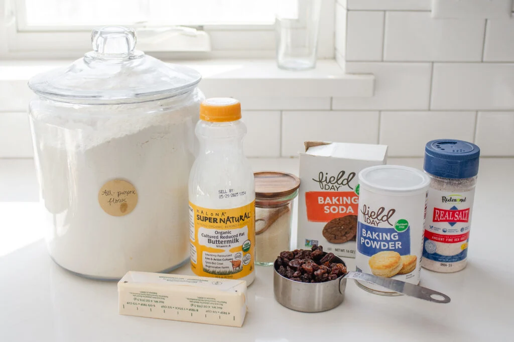 All of the ingredients needed to make buttermilk Irish scones laid out on a white countertop.