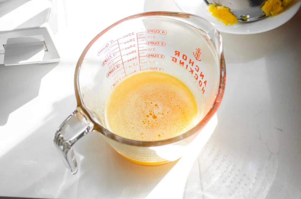 Fresh orange juice in a measuring cup.