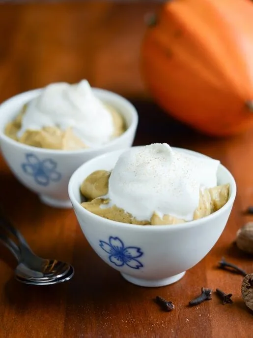 Pumpkin Pudding bowls with a mini squash behind the bowls.