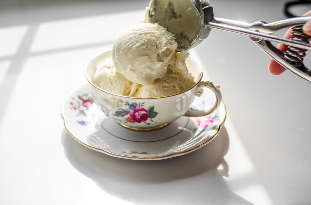 Scooping ice cream into a German teacup.