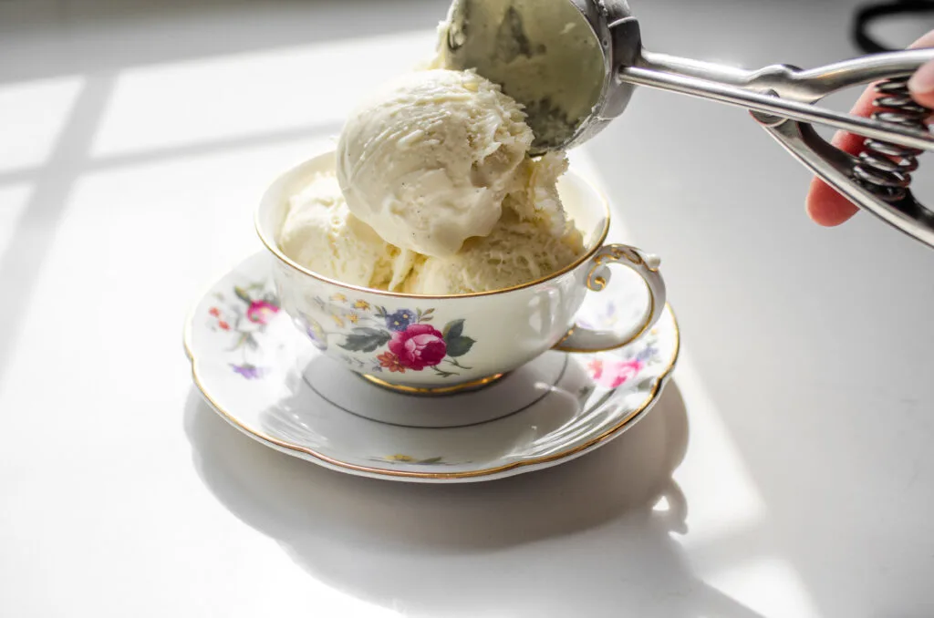 Scooping ice cream into a German teacup.