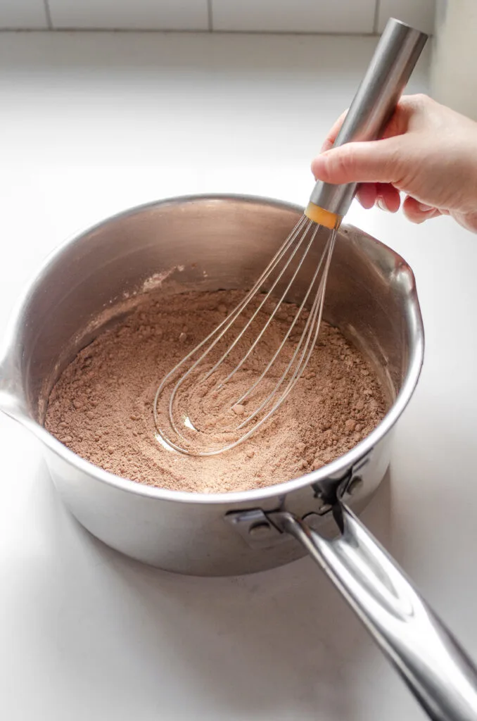 Whisking the dry ingredients together in the saucepan.