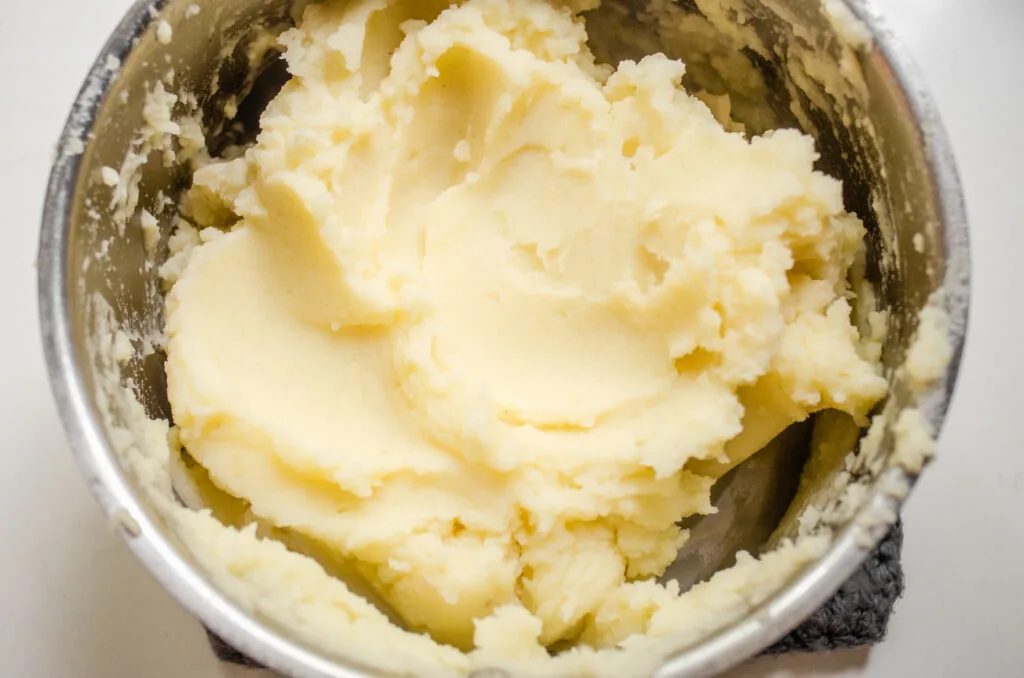 A close up shot of mashed potatoes made with a potato ricer.
