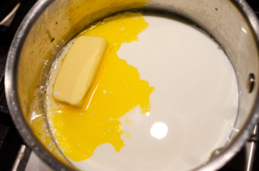Butter and milk warming in a pan.