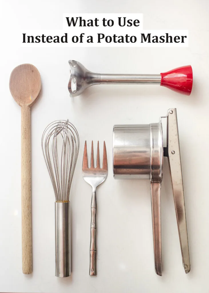 Different kitchen tools that you can use to mash potatoes laid out on a white countertop.