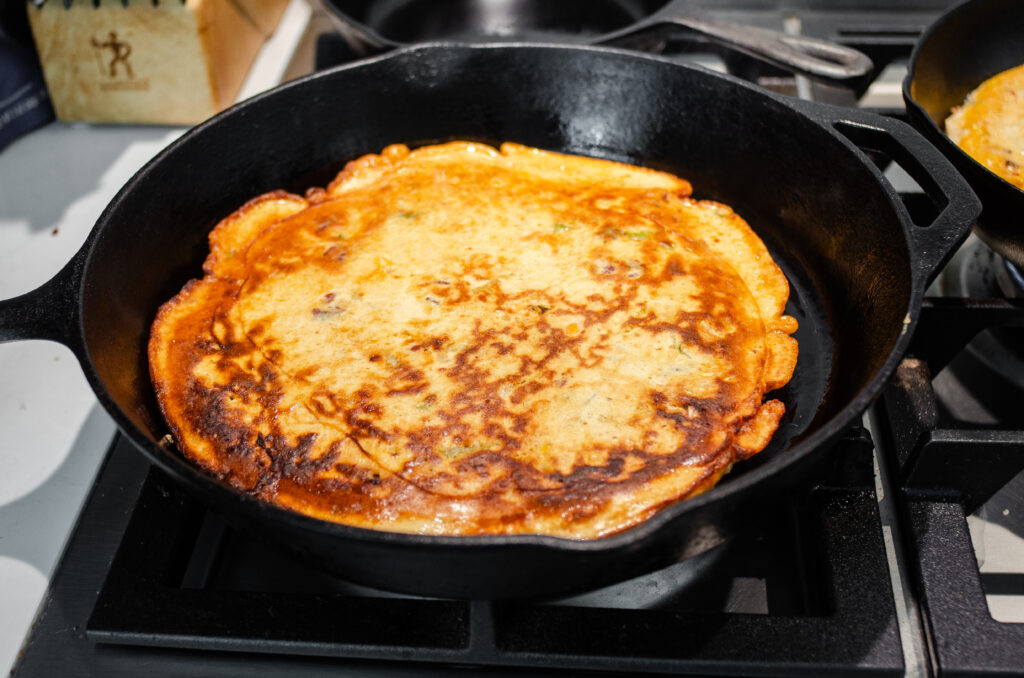 The flipped pancake in the skillet. 
