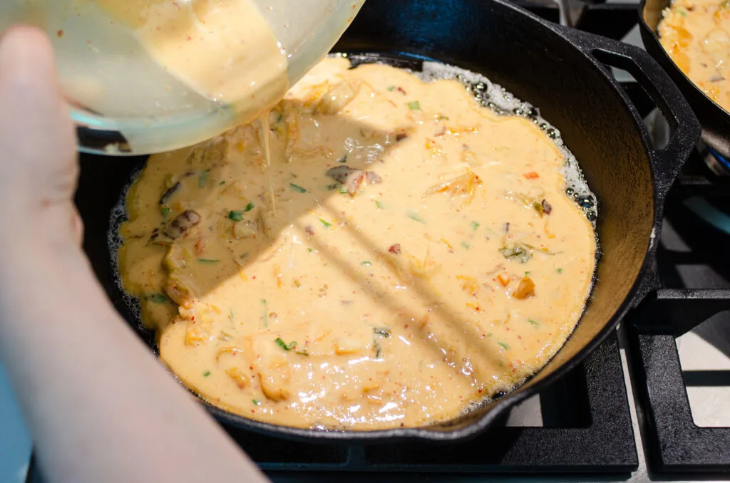 Pouring the batter into the hot skillet.