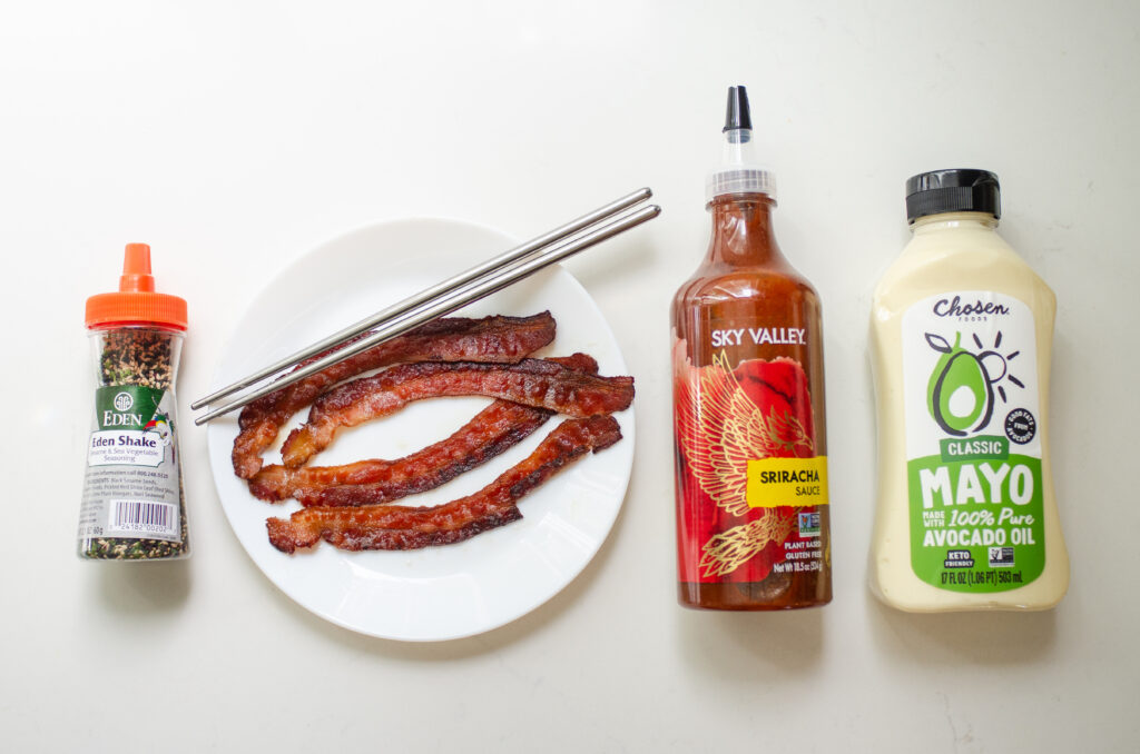 Optional extra ingredients and toppings laid out on a white countertop.