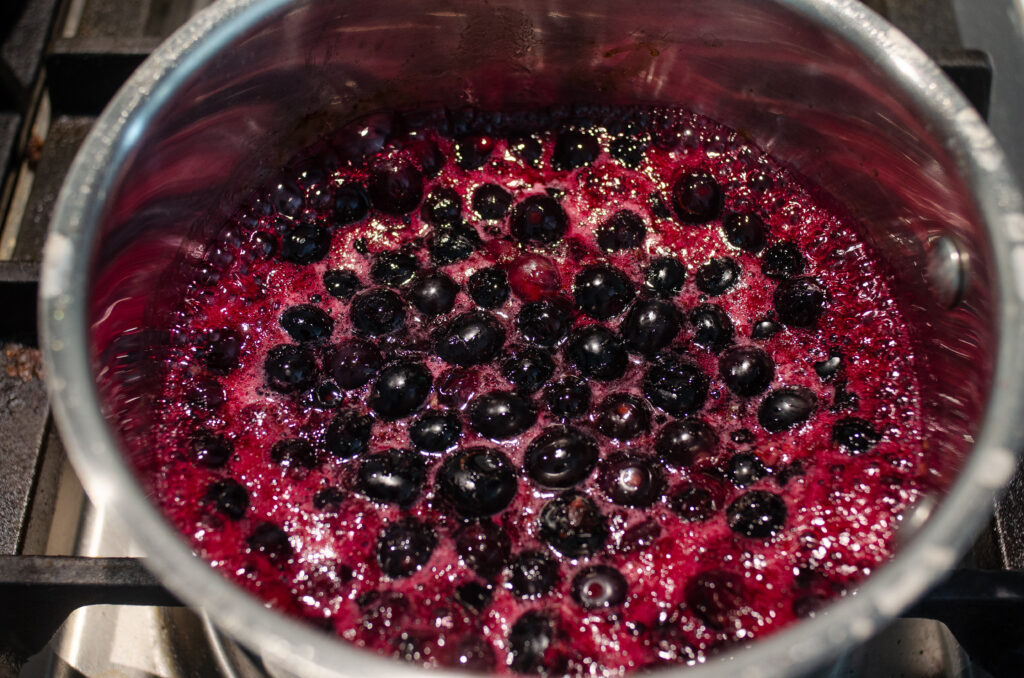 Blueberries simmering in a pan.