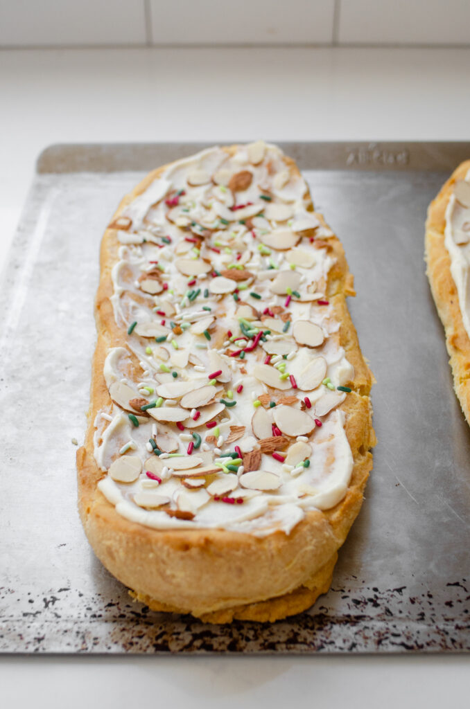 Adding colorful sprinkles as well as the sliced almonds.