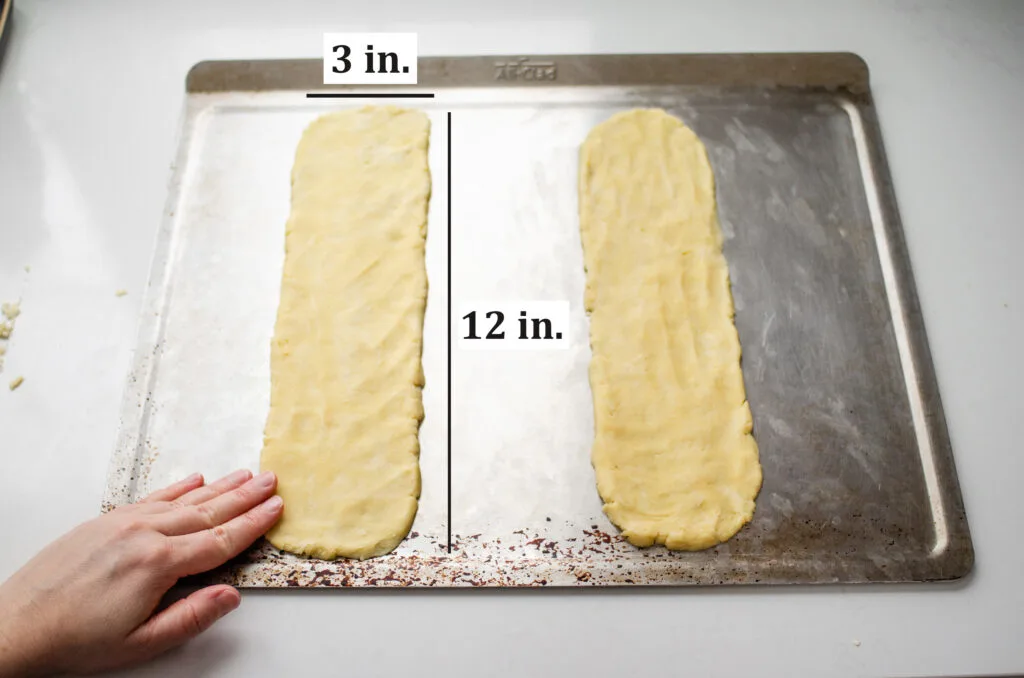 Patting the dough out into two 12x3 inch pieces.