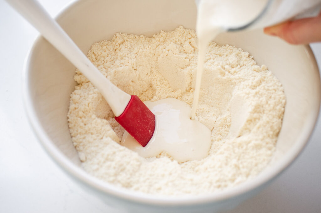 Pouring the starter/milk mixture into the well.