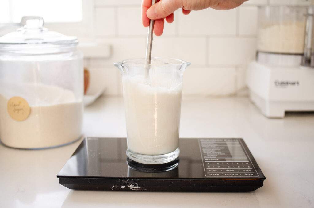 Mixing together the sourdough starter and milk.