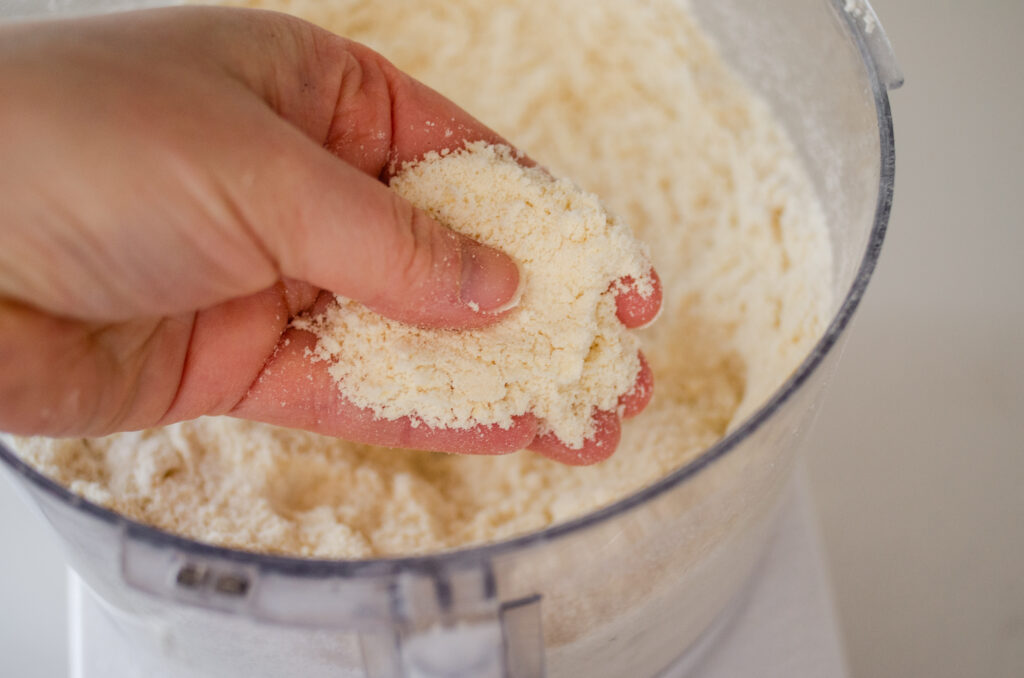 A hand holding the butter/flour mixture to demonstrate the proper texture.