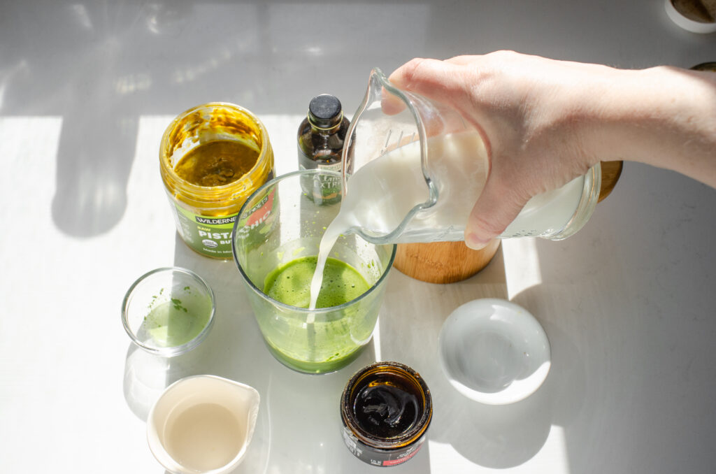 Pouring the milk over the matcha/pistachio mixture.
