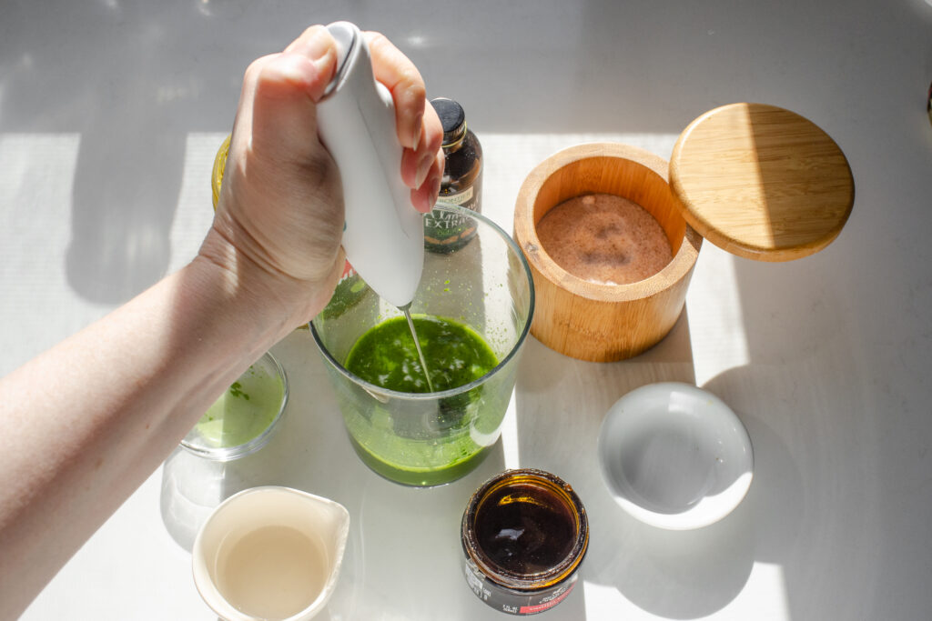 Mixing together the ingredients for the pistachio matcha portion of the latte.
