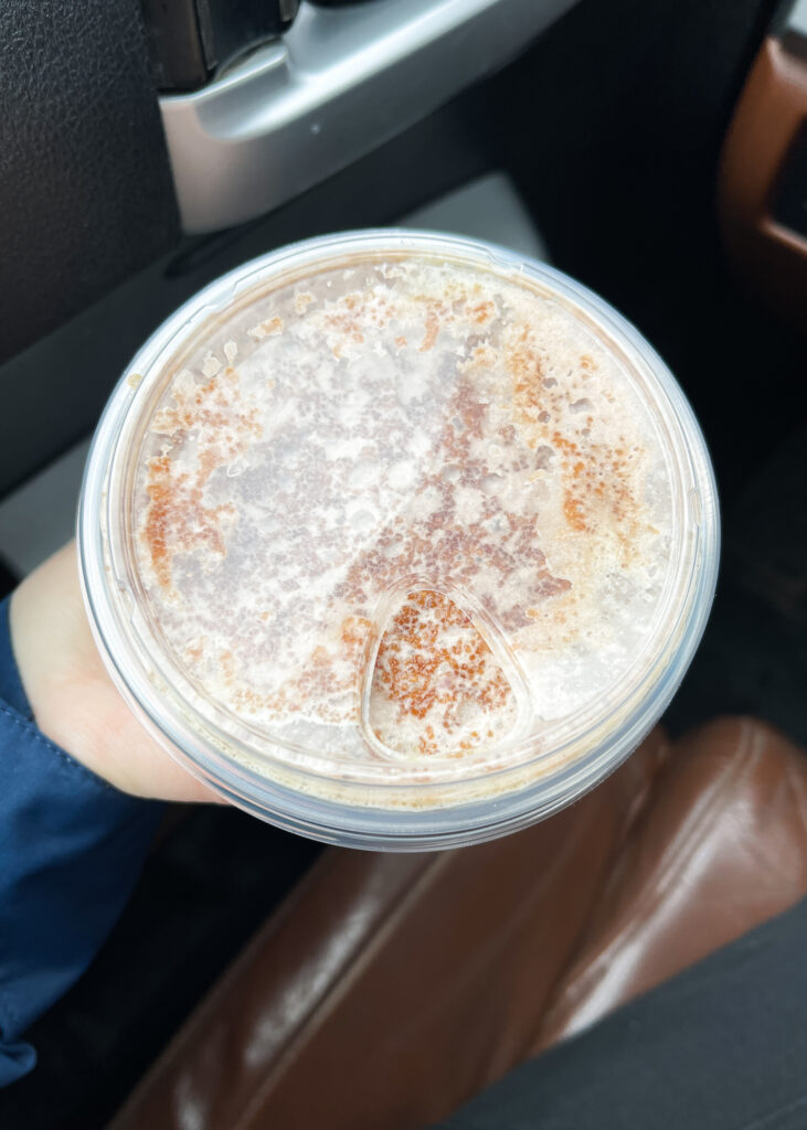 A top-down view of the Starbucks Iced Dubai Chocolate Matcha to show the topping.