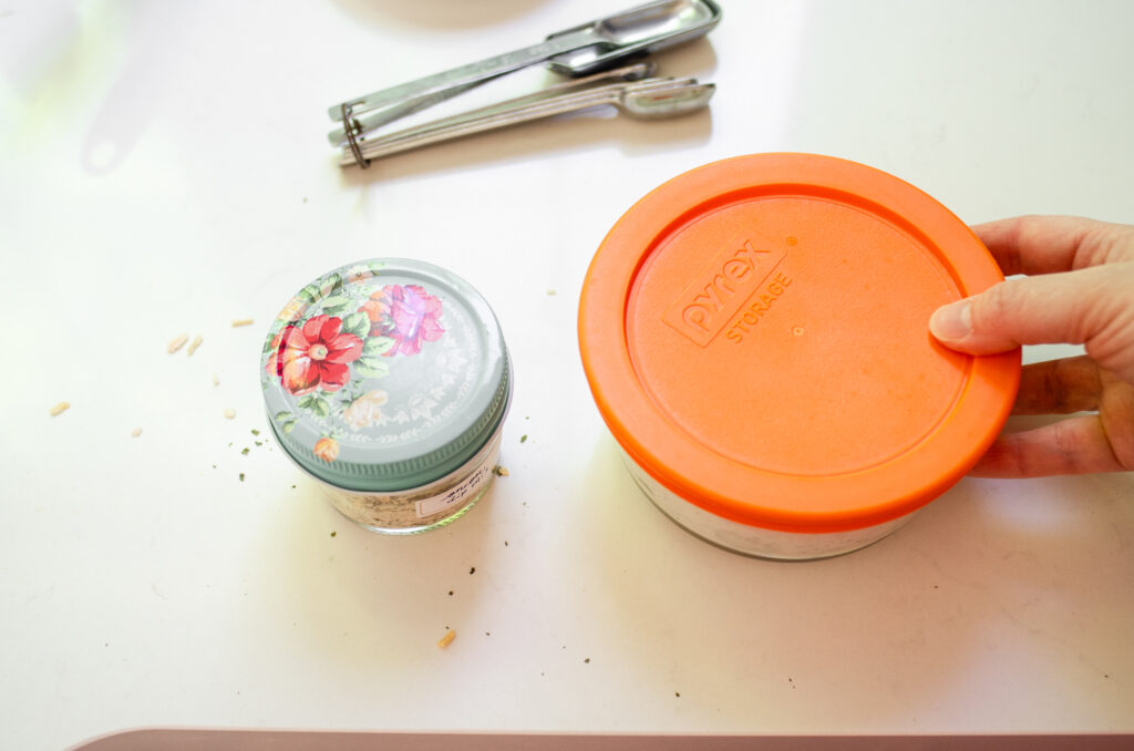 Placing the lid on the storage container.