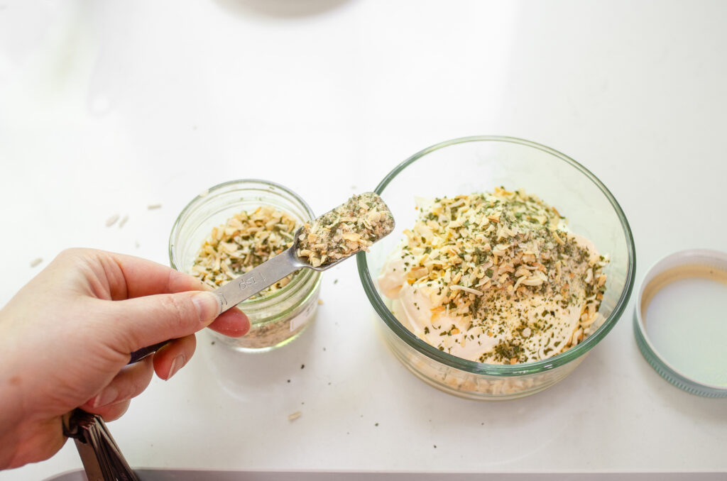 Add the onion dip mix to sour cream in a glass storage container.