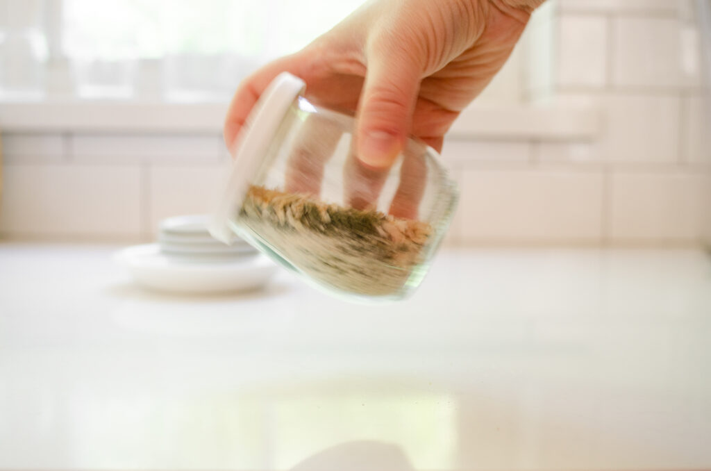 Shaking the jar to mix the ingredients together.