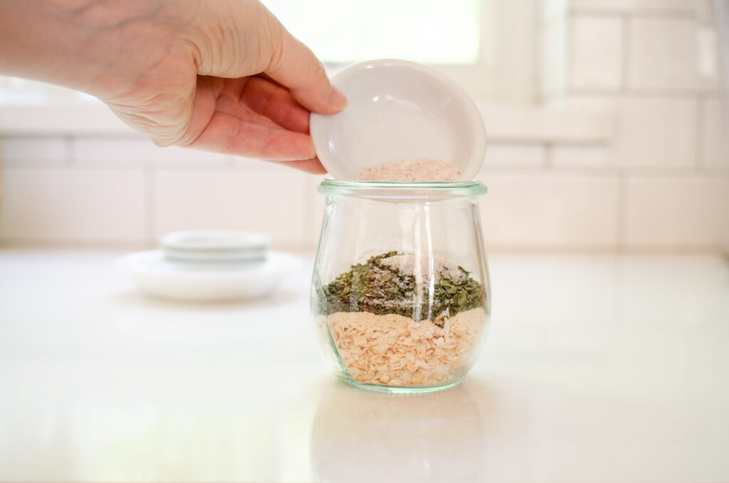 Pouring the ingredients into a small jar.