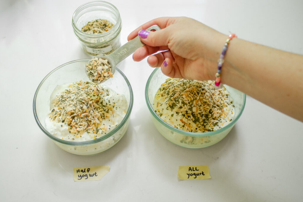 Adding the onion dip mix to the Greek yogurt.