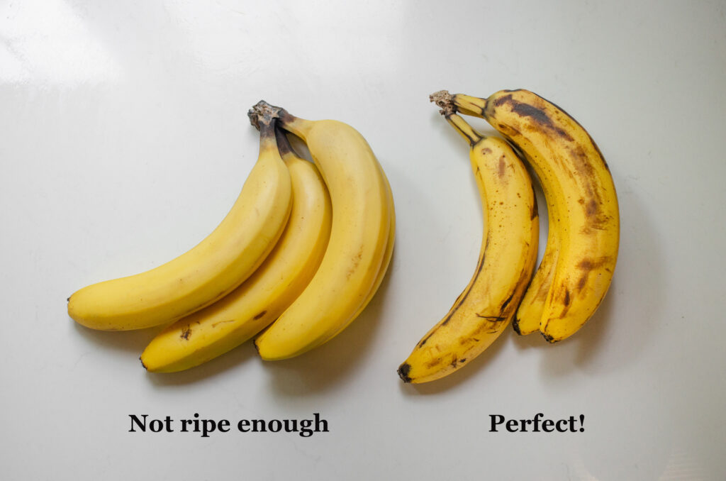 A side by side comparison of bananas that aren't ripe enough for smoothies vs ones that are darkly speckled enough.