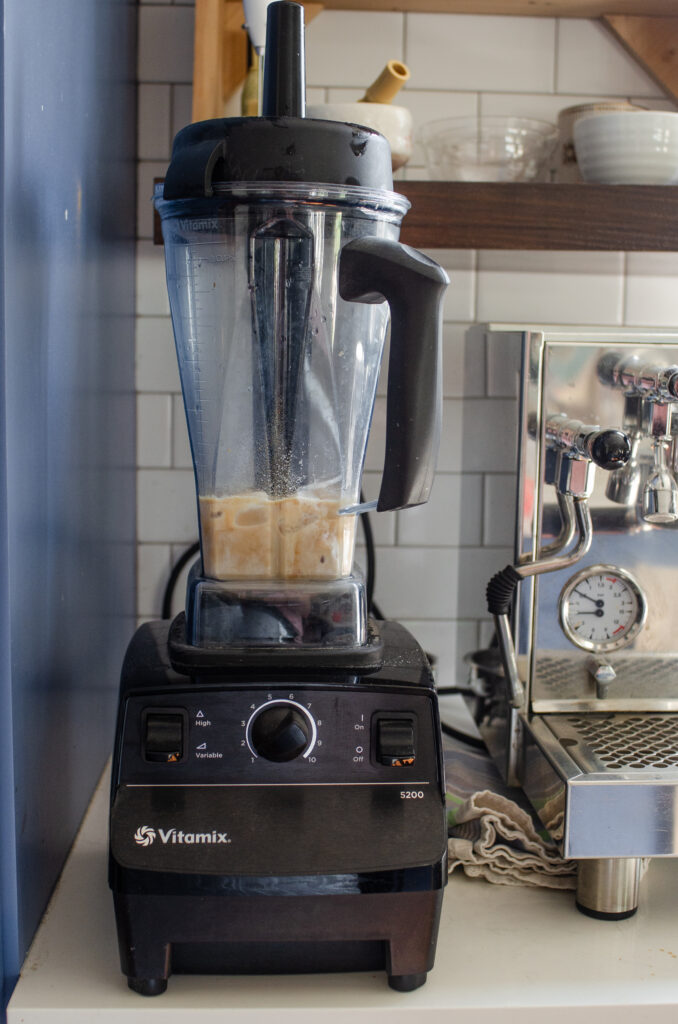 All of the ingredients for the coffee Frappuccino in a blender pitcher ready to be blended.