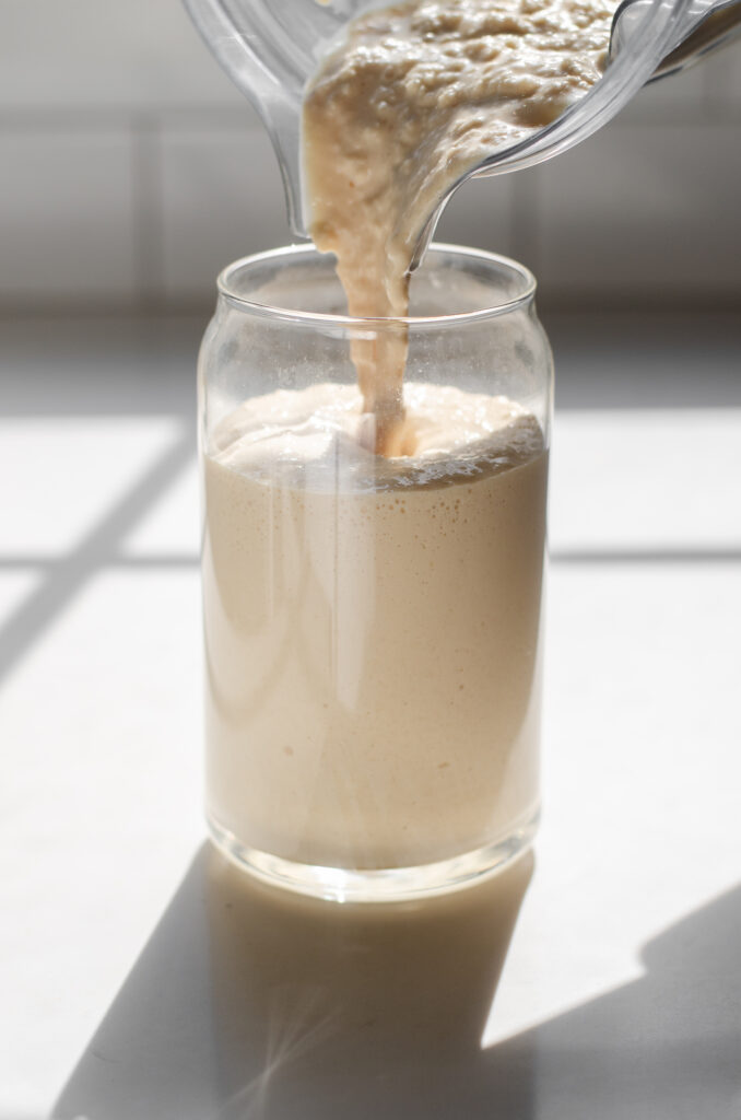 Pouring the frappe into a glass.