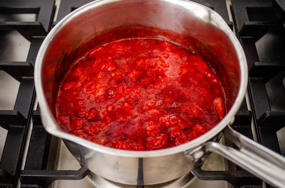 The final cooked strawberry sauce in the pan over the stove.