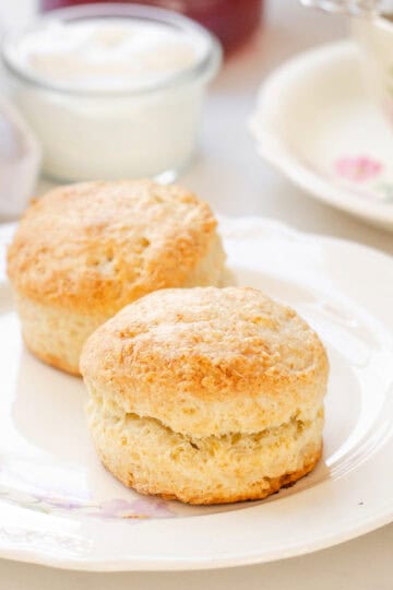 Two sourdough scones on a floral vintage plate.
