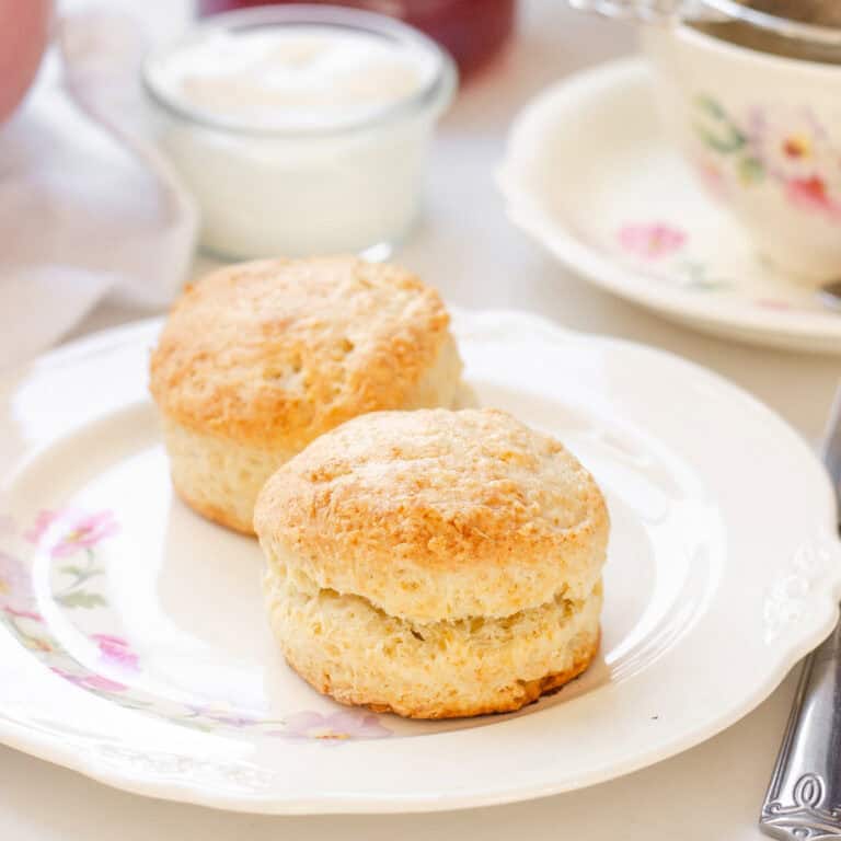 Two sourdough scones on a floral vintage plate.