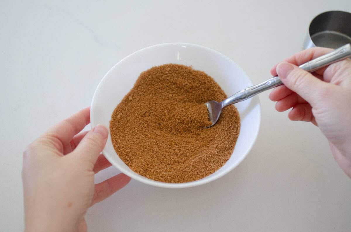 Mixing together the cinnamon sugar mixture with a fork.
